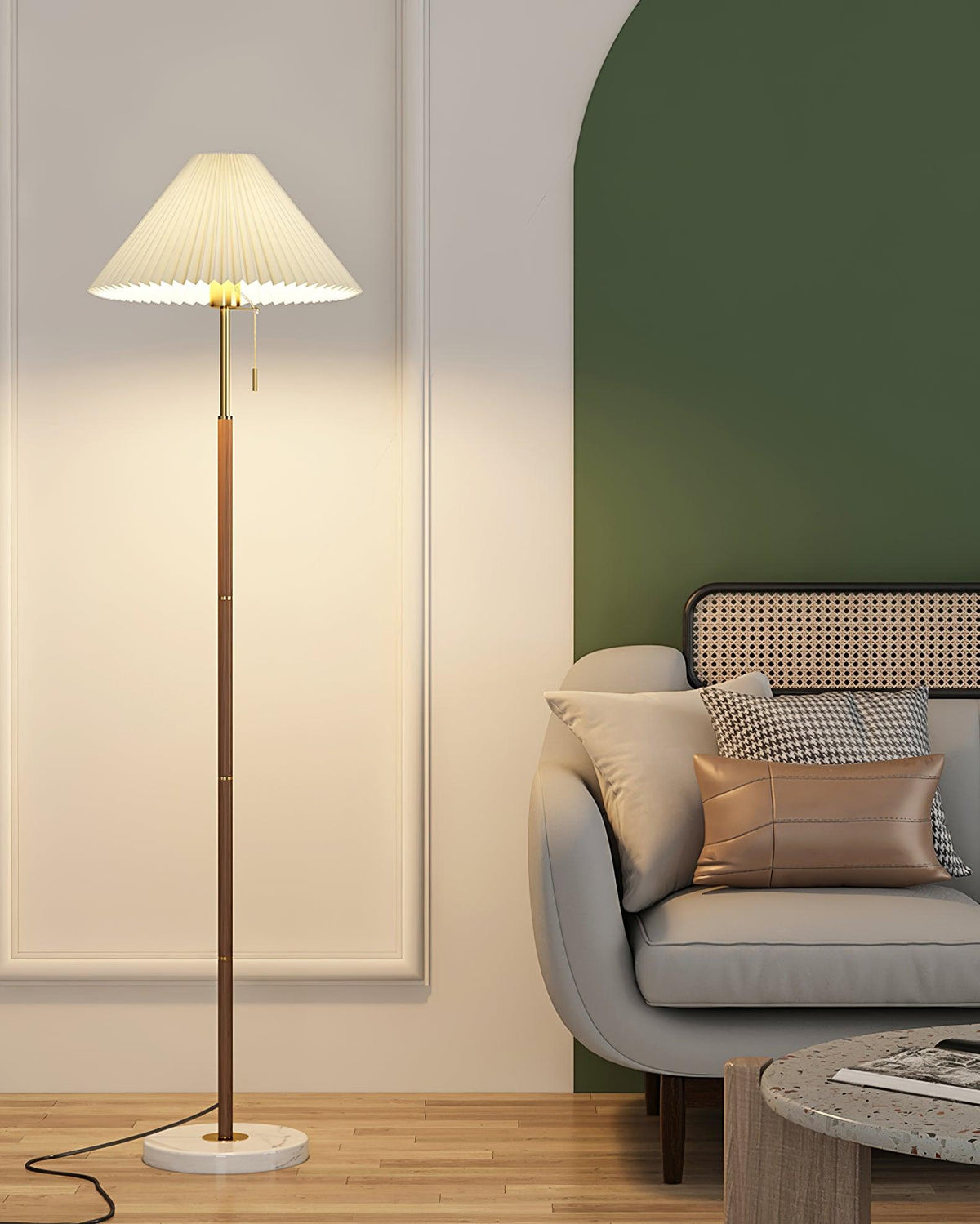 Clérachic floor lamp lit against a sage-green panelled wall, beside a grey sofa with a dusty pink cushion.