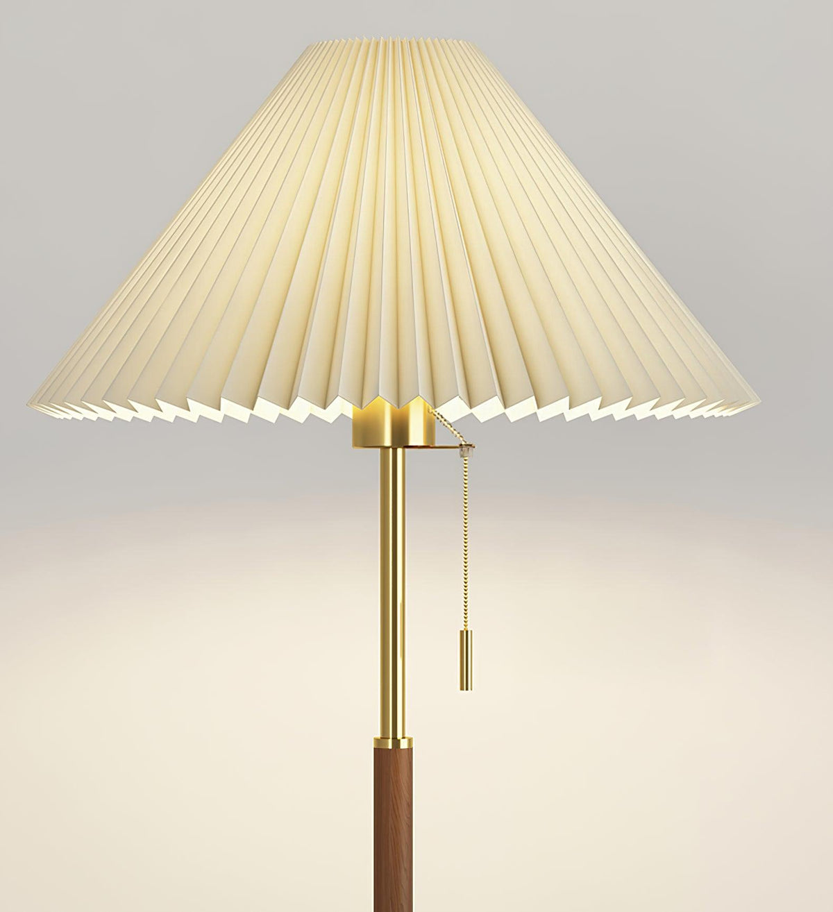 Close-up beneath the Clérachic floor lamp's pleated shade, showing the brass gallery and pull-chain switch.
