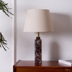 The same Clérachic table lamp sits unlit on the dresser, its shade reading pale grey against the plain white wall.