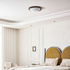 Walnut flush mount ceiling light detail on a white background