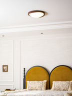 Round walnut ceiling light studio shot on a white background