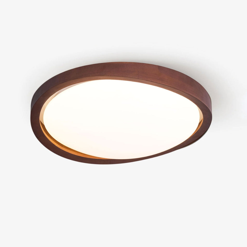 Curved edge walnut ceiling light seen against a white ceiling