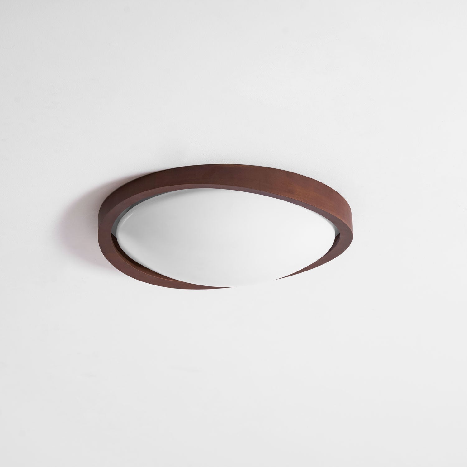 Walnut curved edge ceiling light glowing in a cozy interior