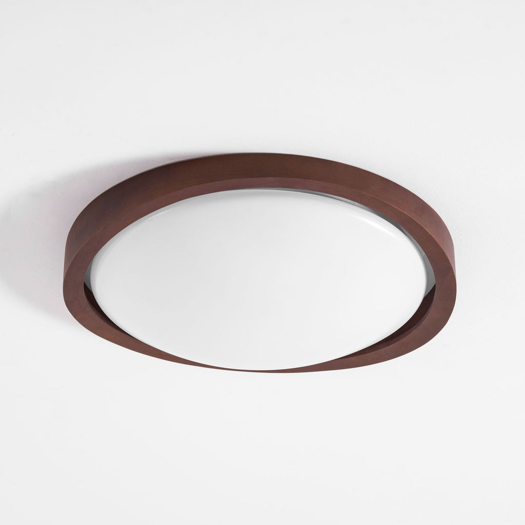 Round walnut ceiling light lighting a quiet living space