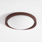 Round walnut ceiling light lighting a quiet living space