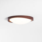 Walnut curved edge ceiling light glowing softly overhead