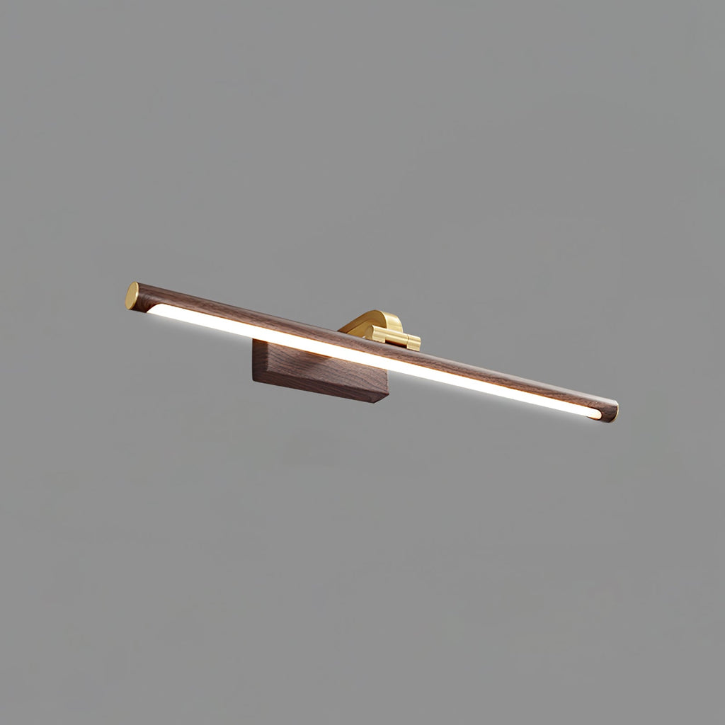 This Clérachic wall light in walnut and brass, lit, shown from a low angle on plain grey.