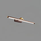This Clérachic wall light in walnut and brass, lit, shown from a low angle on plain grey.