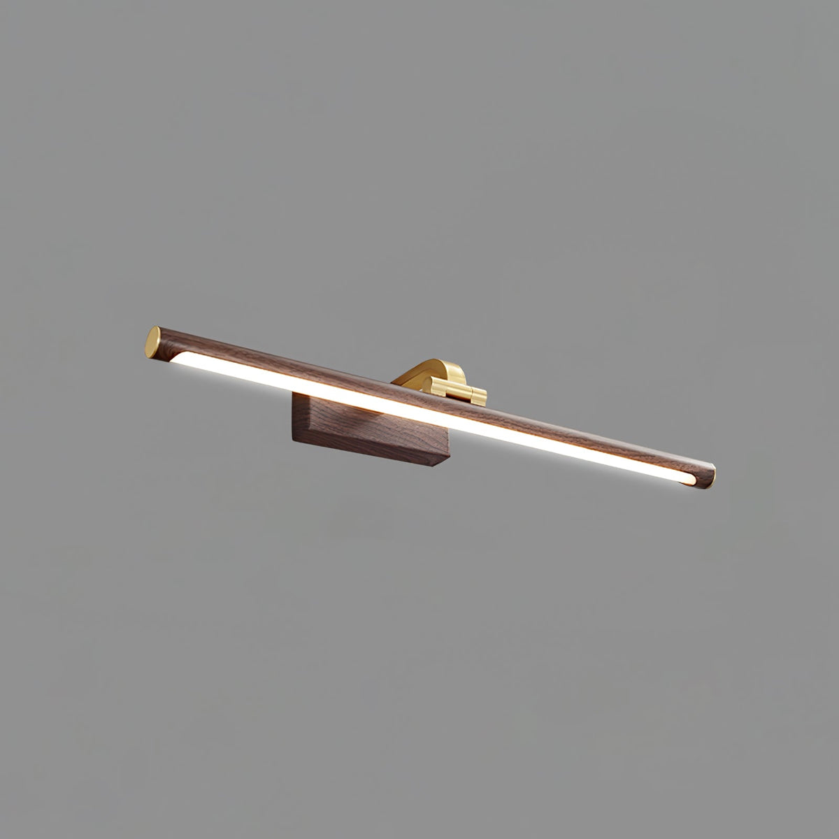 This Clérachic wall light in walnut and brass, lit, shown from a low angle on plain grey.