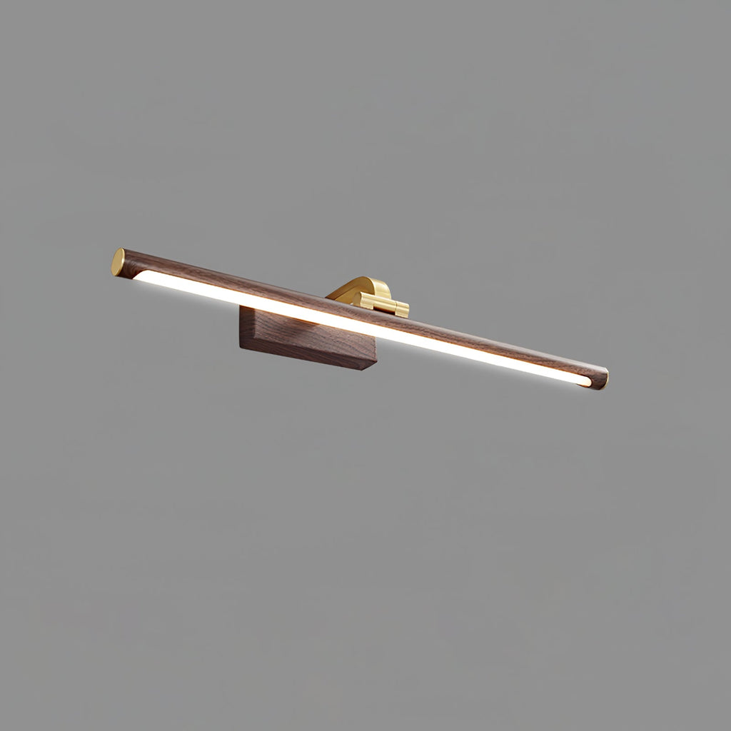 Angled close-up of this Clérachic wall light in walnut and brass, lit, on plain grey.