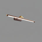 Angled close-up of this Clérachic wall light in walnut and brass, lit, on plain grey.