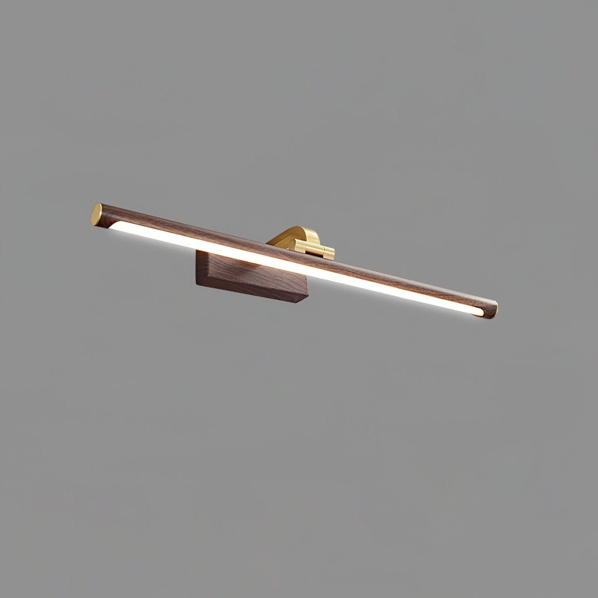 Angled close-up of this Clérachic wall light in walnut and brass, lit, on plain grey.