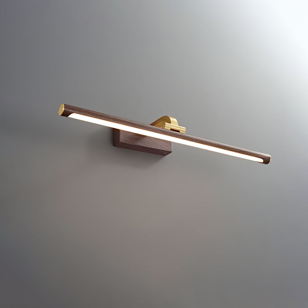 Side view of this Clérachic wall light in walnut and brass, lit, on a plain grey background.