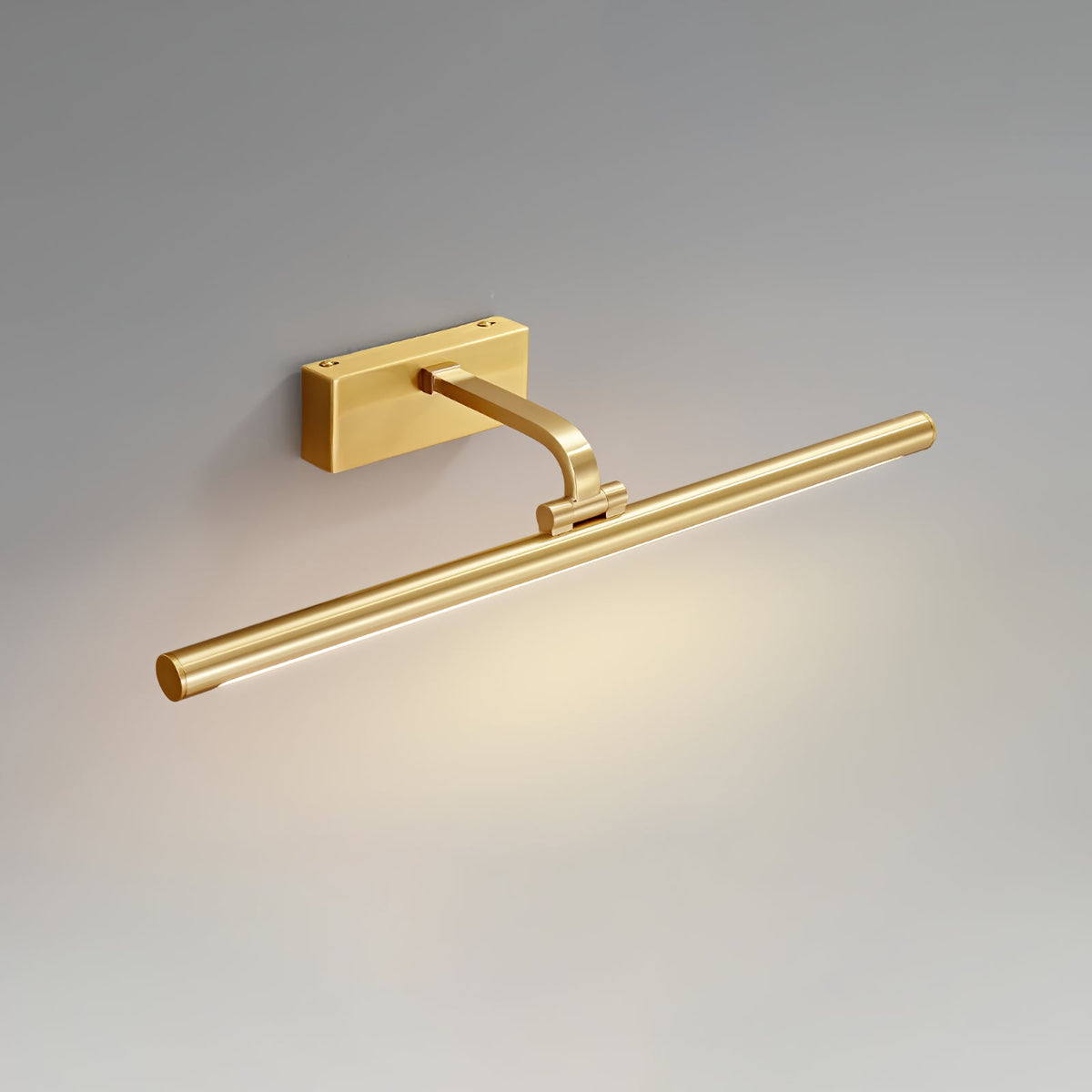 Angled view of this Clérachic wall light in brass, alone on a plain grey backdrop, its pivot bracket visible.