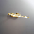Angled close-up of this Clérachic wall light in brass, lit, on a plain grey backdrop.