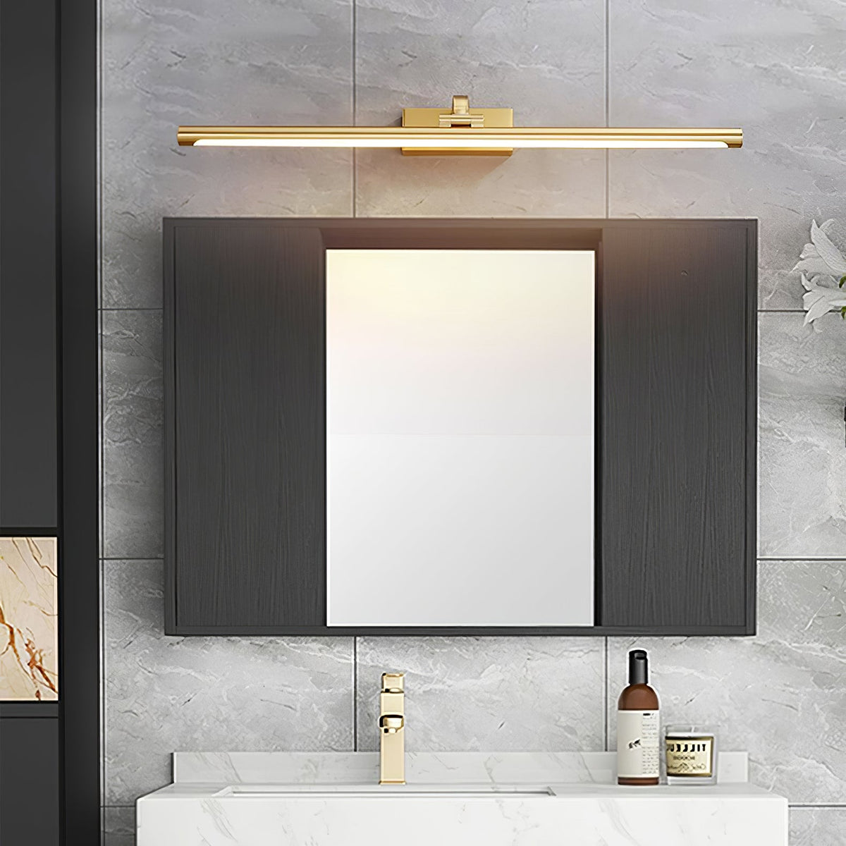 Mirrored dark cabinet doors sit below this Clérachic wall light in brass, over a white bathroom vanity.