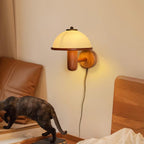 Mushroom wall lamp glowing softly beside framed wall art
