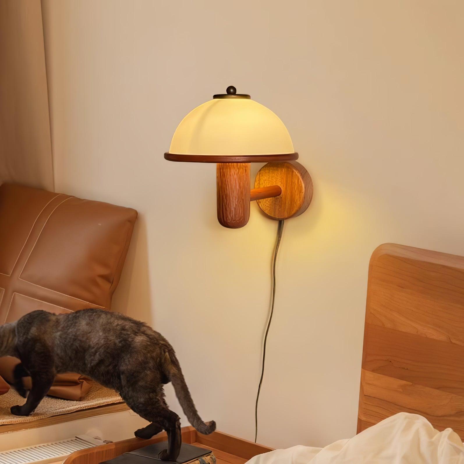 Mushroom wall lamp glowing softly beside framed wall art