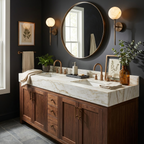 A pair of Clérachic wall sconces in brass flank a round mirror above a marble bathroom vanity.