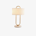 Photographed unlit against a plain white background, this Clérachic table lamp shows its full brass loop frame and marble base.