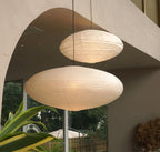 Washi paper pendant light glowing above a living space