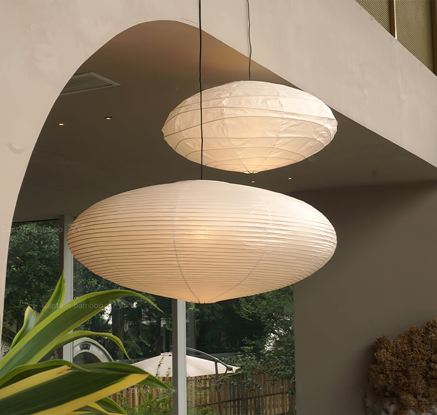 Washi paper pendant light glowing above a living space