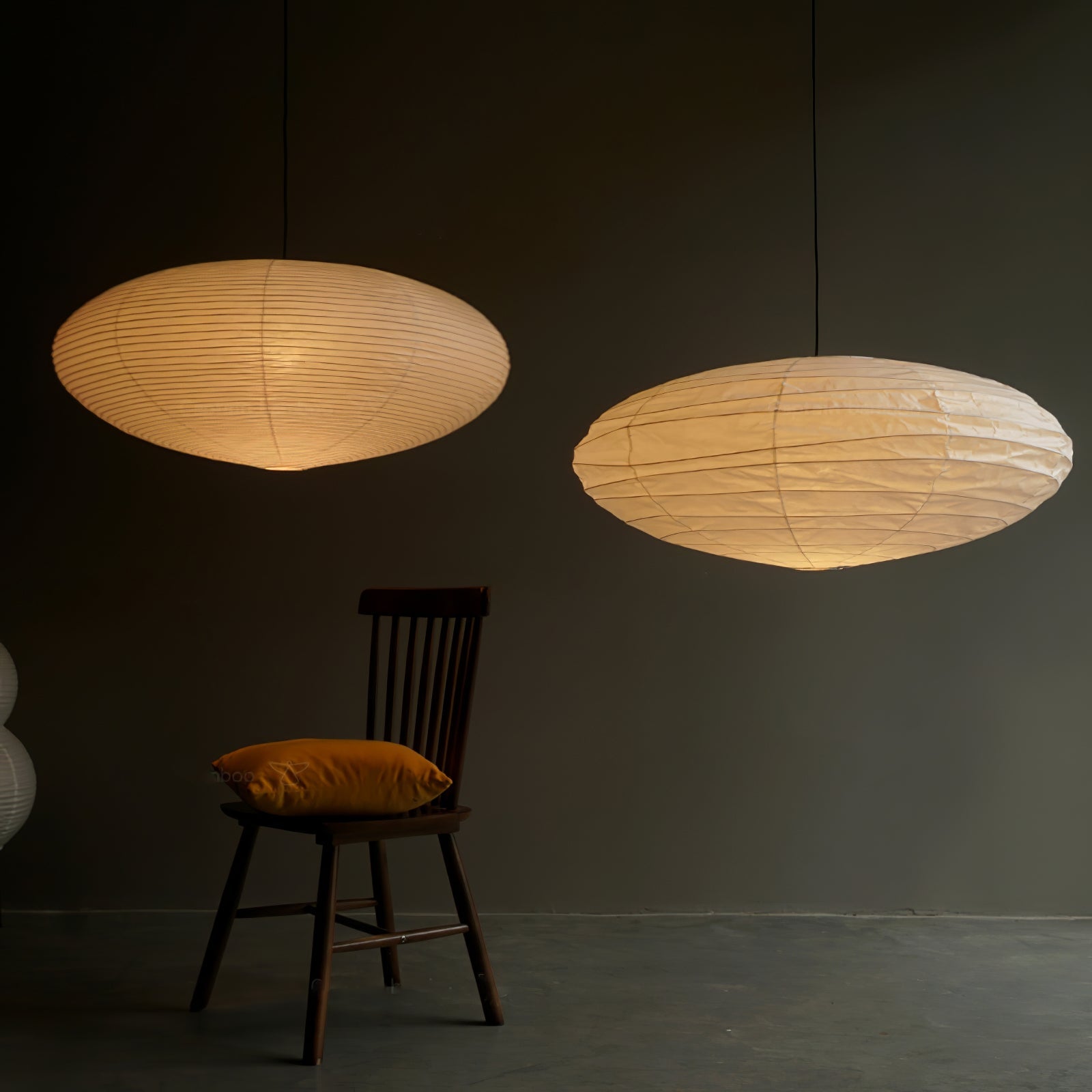 Handmade paper swag pendant lit in a quiet room