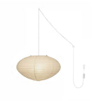 White washi paper swag pendant light glowing in a styled room