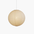 Washi paper pendant glowing above a dining setting