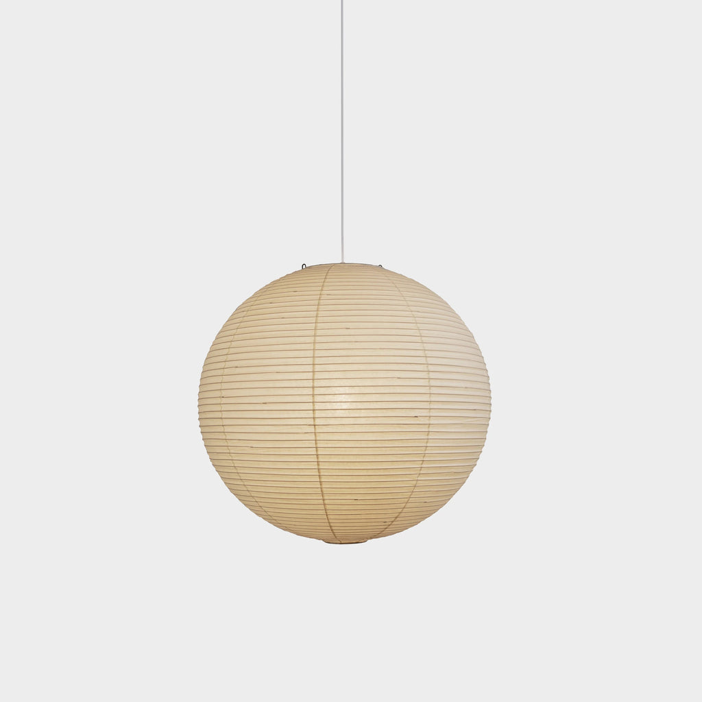 White mulberry paper pendant light glowing over a room