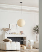 Round washi paper pendant glowing over a room