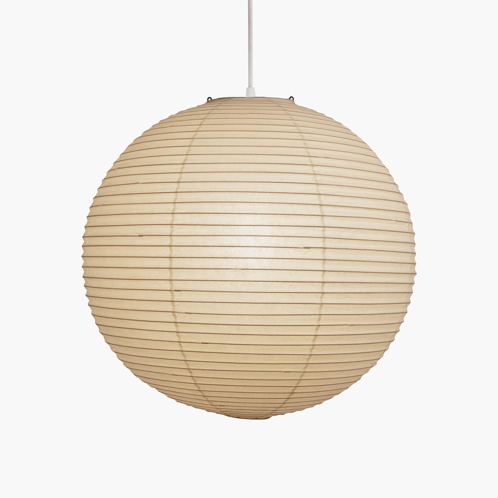 White washi paper pendant glowing against a wall