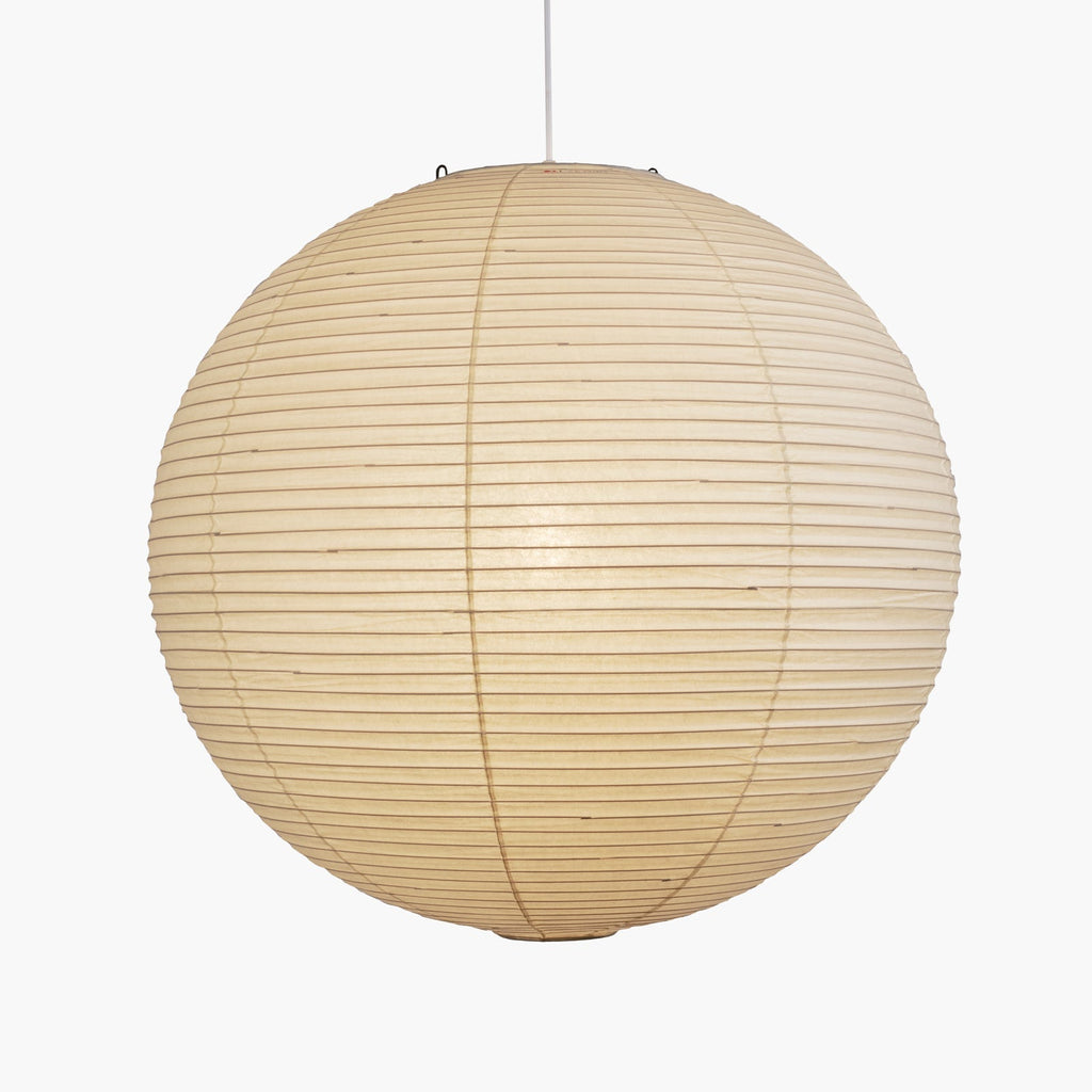Paper ceiling pendant lit warm over seating