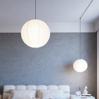 Mulberry paper globe pendant light lit warmly overhead