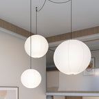White paper sphere pendant light suspended in a room