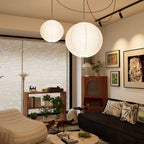 Mulberry paper globe pendant light glowing above a setting