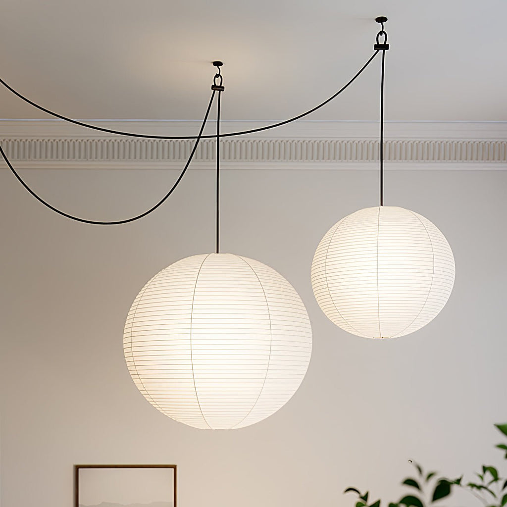 Mulberry paper globe pendant light lit warmly overhead