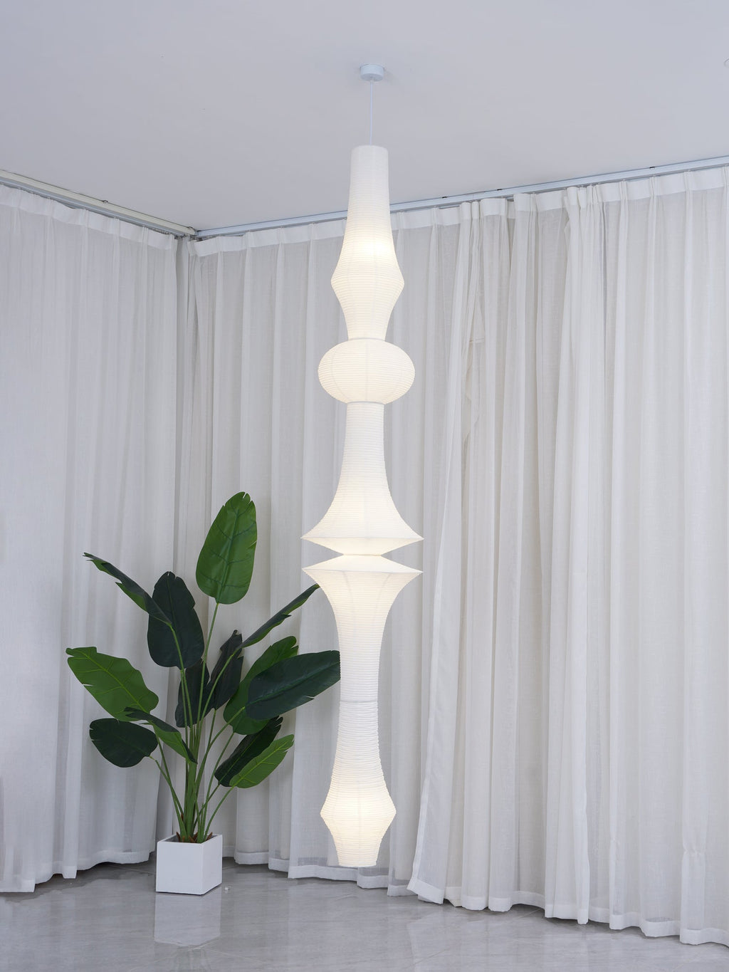 Mulberry paper pendant lit warm above a dining table