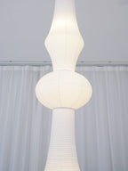 Slender white paper pendant shade shown from below