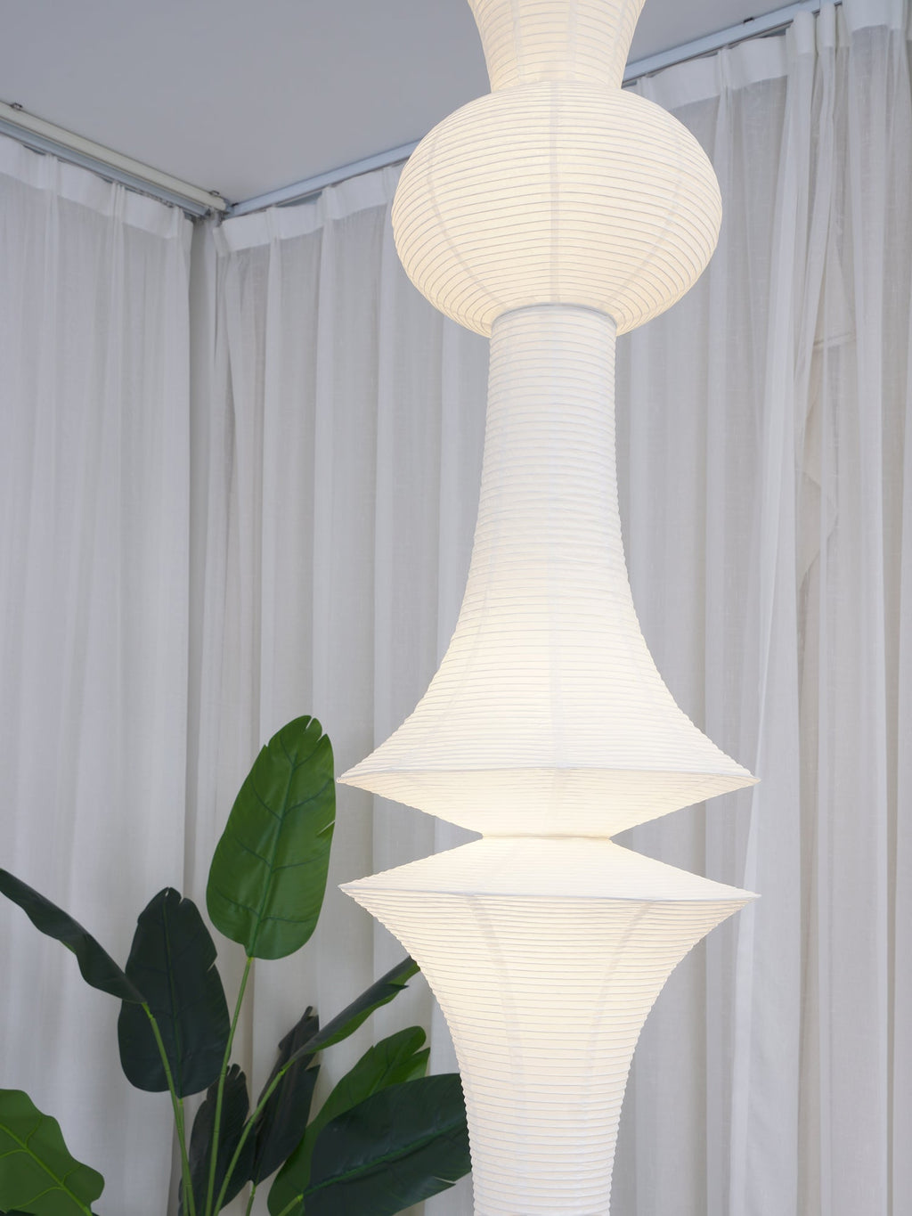 White washi paper pendant glowing in a calm room