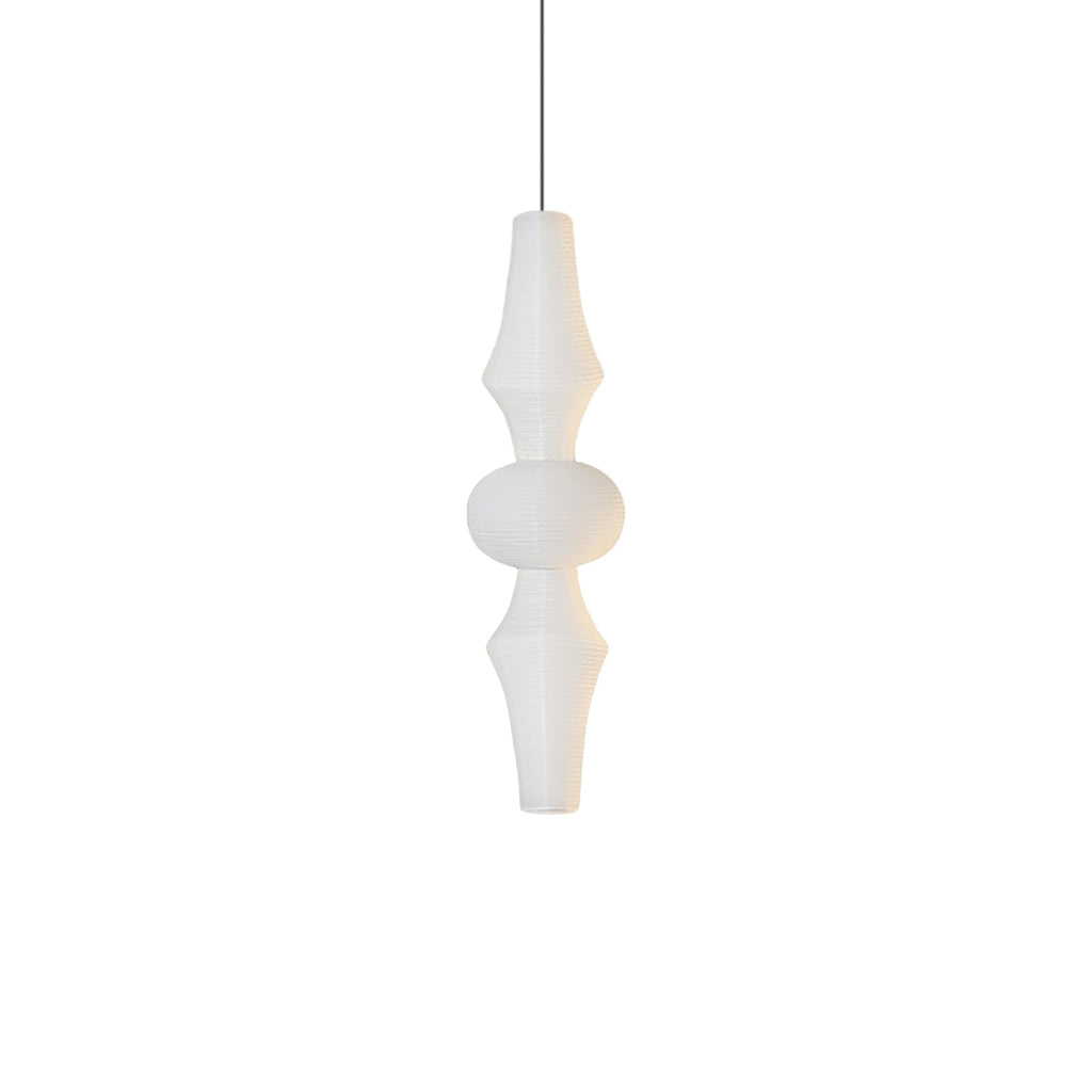 Tall white washi paper pendant glowing in a high-ceiling room
