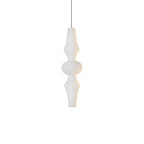 Tall white washi paper pendant glowing in a high-ceiling room