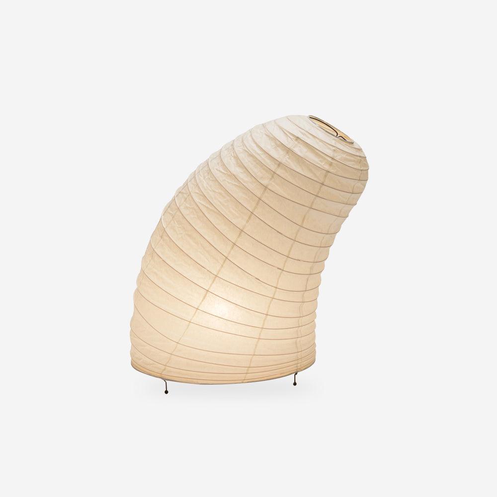 White mulberry paper table lamp on a console in a warm room