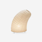 White mulberry paper table lamp on a console in a warm room
