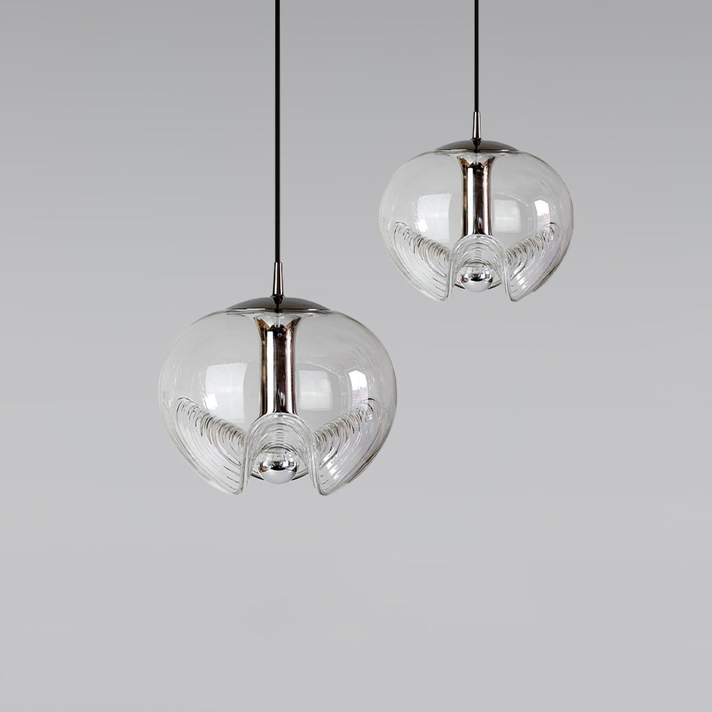 Two clear glass pendants with silver frames hang at different heights against a plain grey backdrop, this Clérachic fixture shown as a pair.