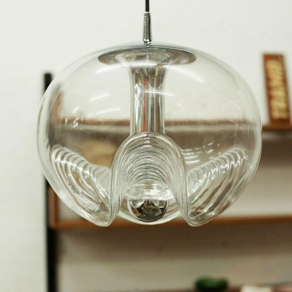 Close view of this Clérachic pendant's ribbed clear glass shade, its scalloped underside and exposed socket shown in sharp detail.