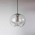 Product shot of this Clérachic pendant's clear glass shade and silver frame, unlit against a soft grey gradient background.