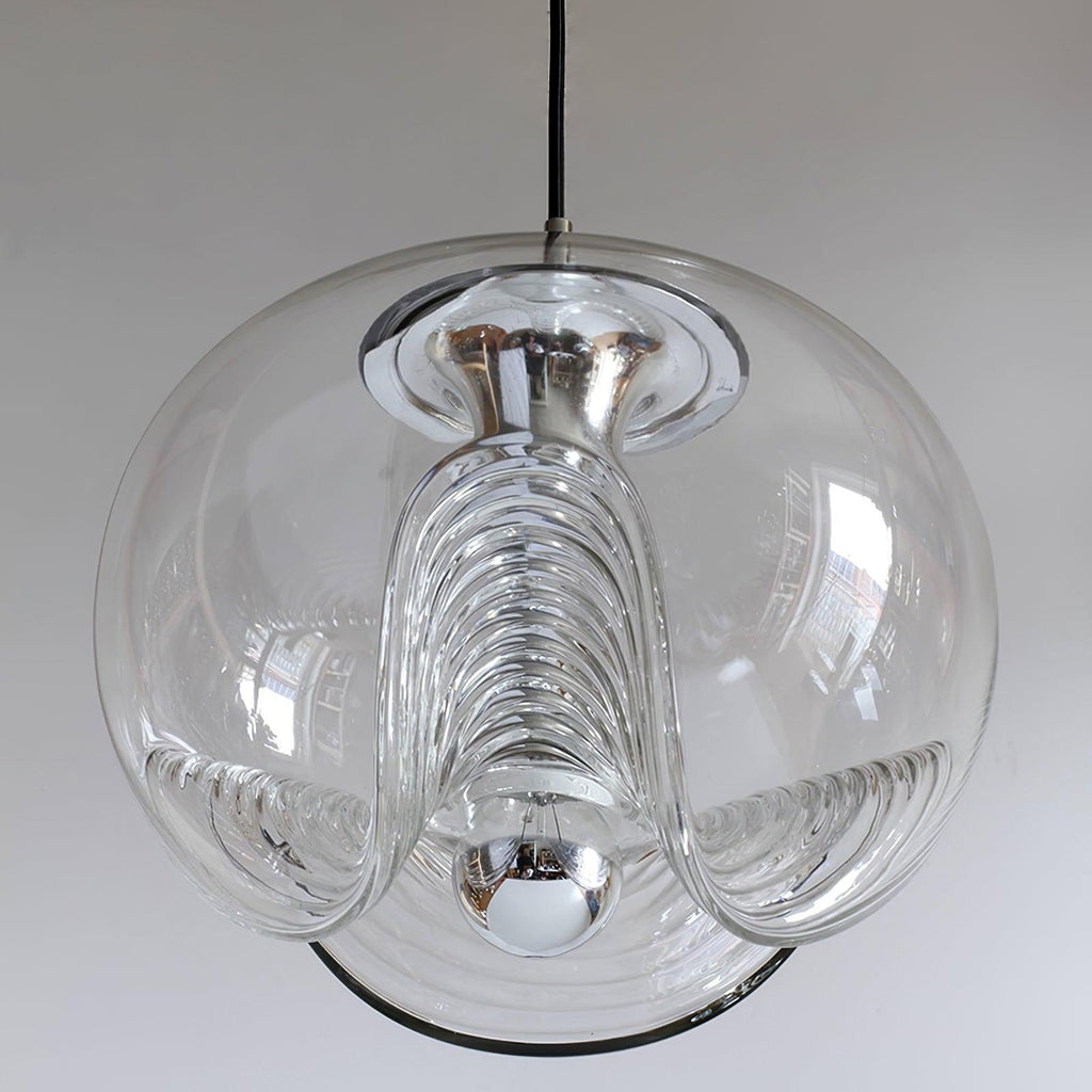 Close view of this Clérachic pendant's clear glass shade, its ribbed scalloped underside and chrome fitter shown in sharp detail against white.
