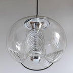 Close view of this Clérachic pendant's clear glass shade, its ribbed scalloped underside and chrome fitter shown in sharp detail against white.