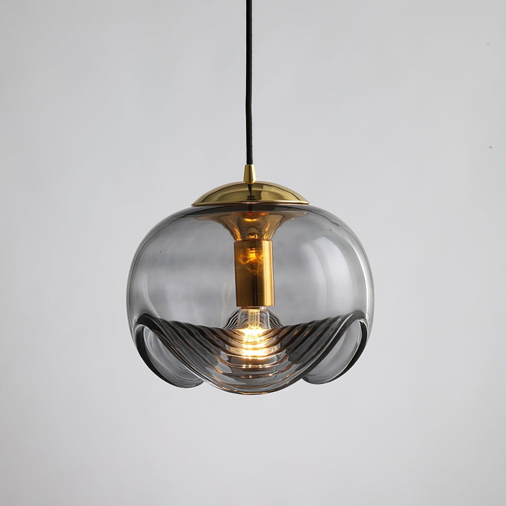 Product shot of this Clérachic pendant's smoky grey glass shade and gold frame, lit against a plain grey backdrop.